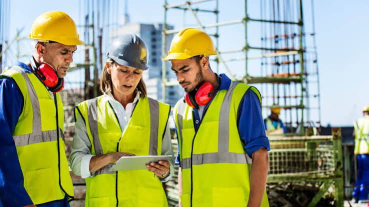 Construction professionals reviewing project plans on site